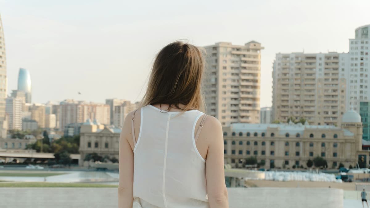Woman looking at cityscape with modern buildings, date night in Alberta
