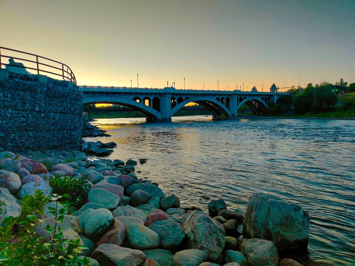 Gray concrete bridge over river during daytime: date idea in Alberta