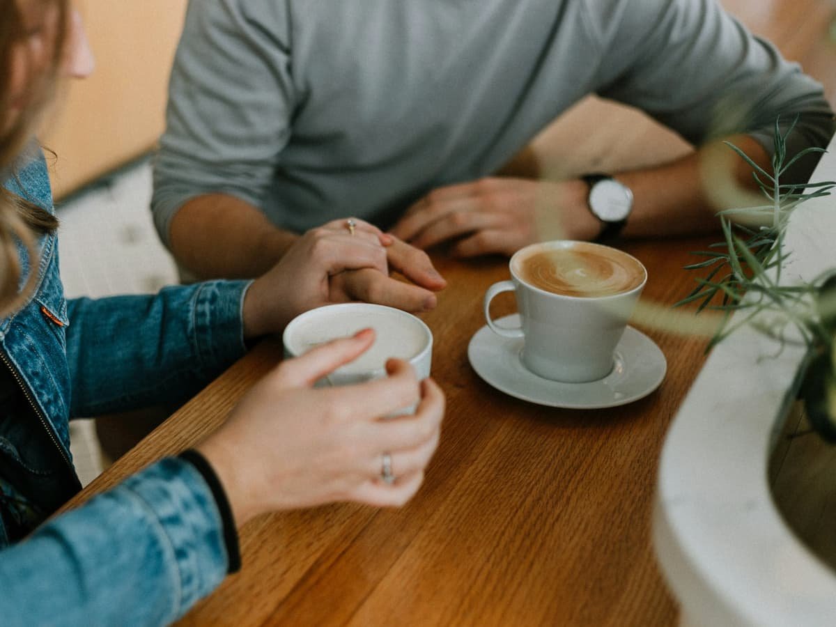 Two mugs with coffee on table: date idea in Alberta
