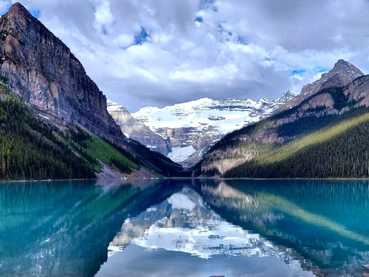 Mountain near body of water during daytime: date idea in Alberta
