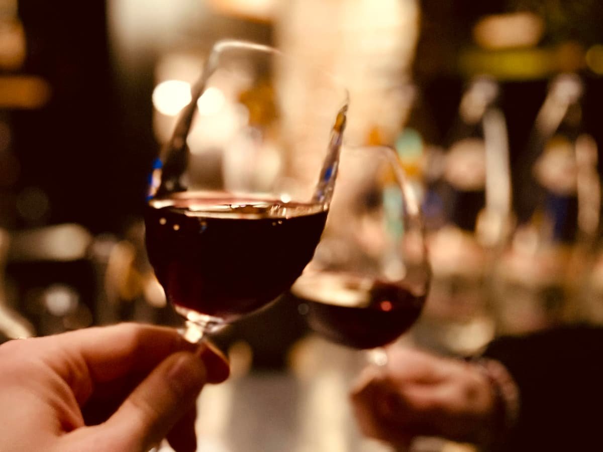A person holding a glass of wine in their hand: date idea in Alberta