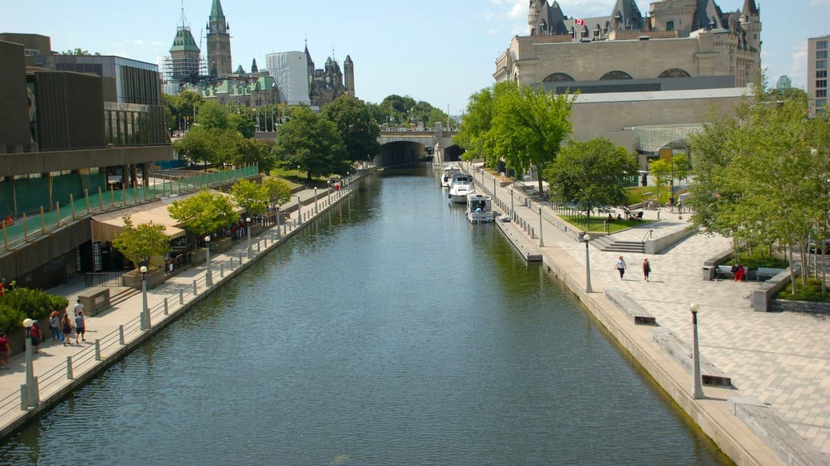 A river running through a city next to tall buildings