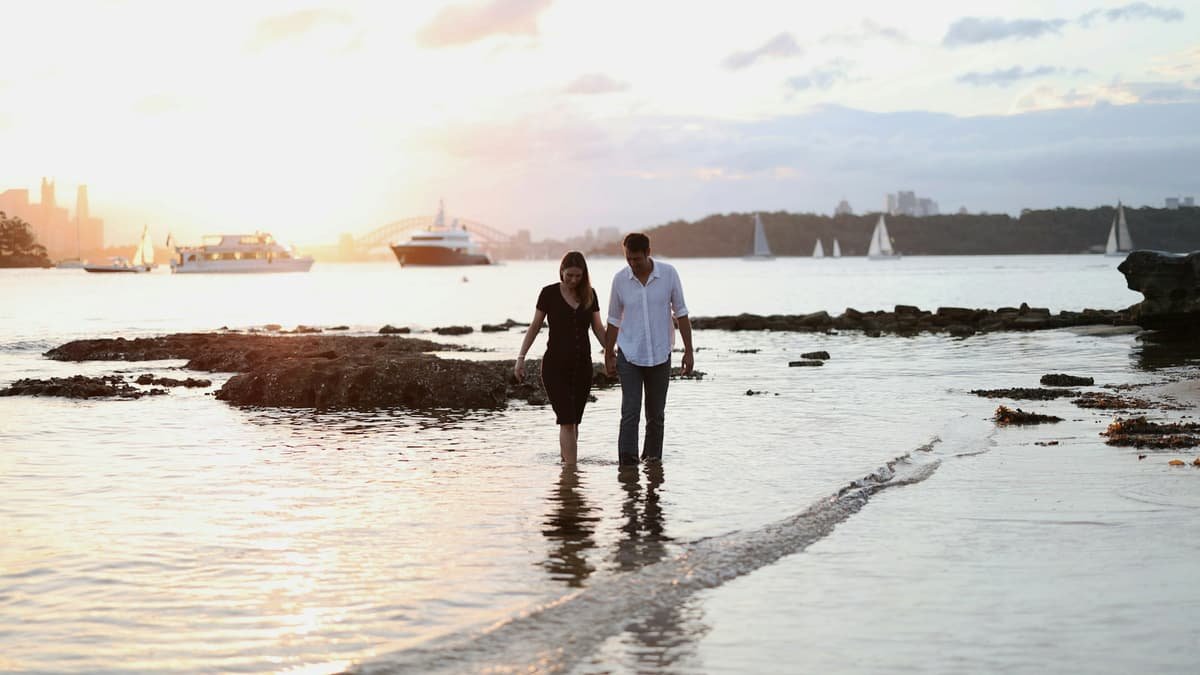 A man and a woman are walking in the water, date night in British Columbia