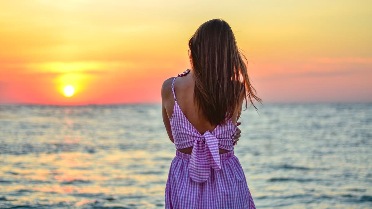A woman standing on a beach at sunset, date night in Manitoba
