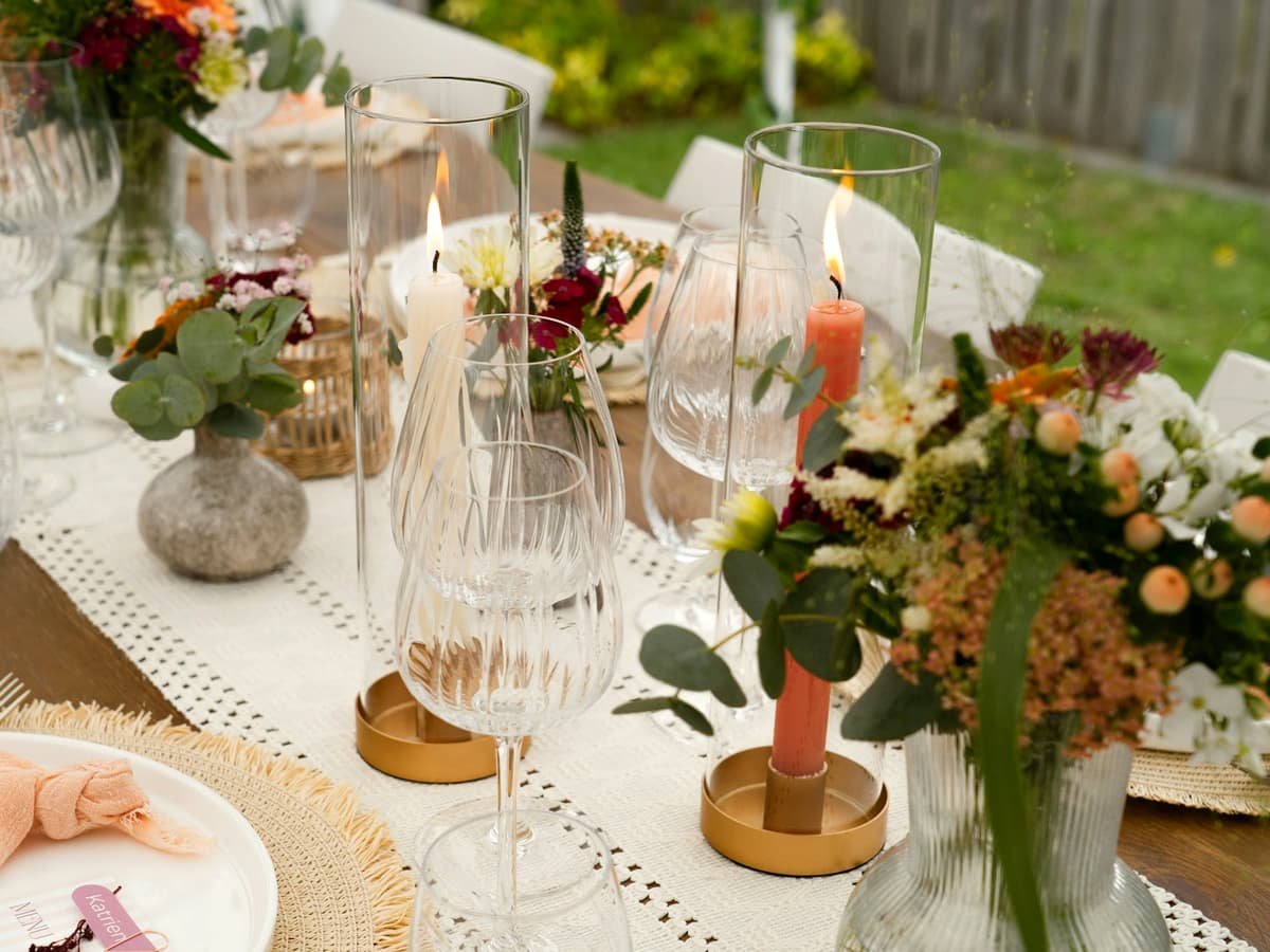 A beautifully decorated outdoor table with flowers, candles, and glassware: date idea in Manitoba