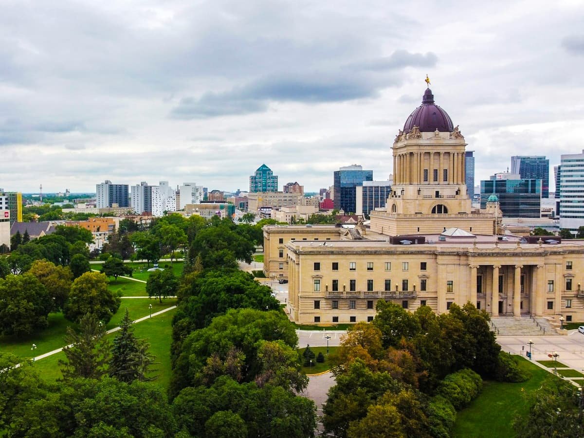 Green trees near brown concrete building during daytime: date idea in Manitoba