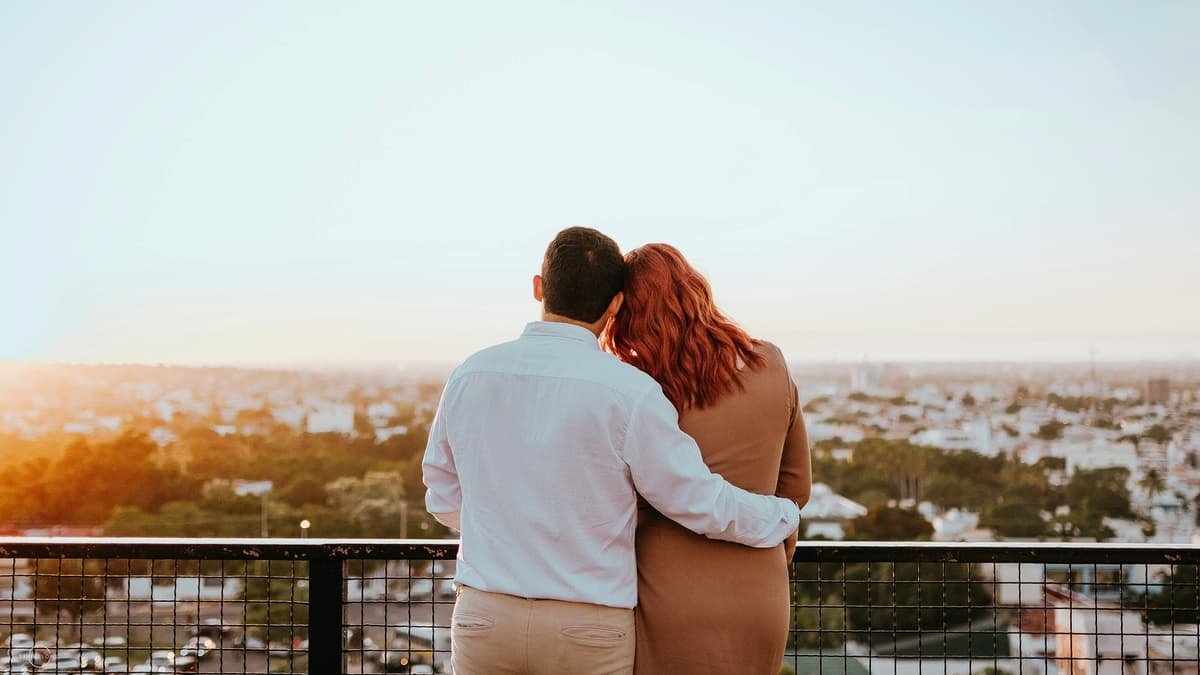 Couple watching city skyline at sunset, date night in Newfoundland and Labrador