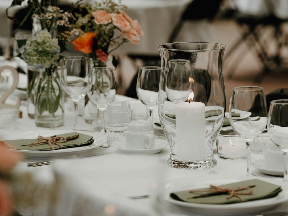 A decorated table setting with a lit candle and flowers: date idea in Newfoundland and Labrador