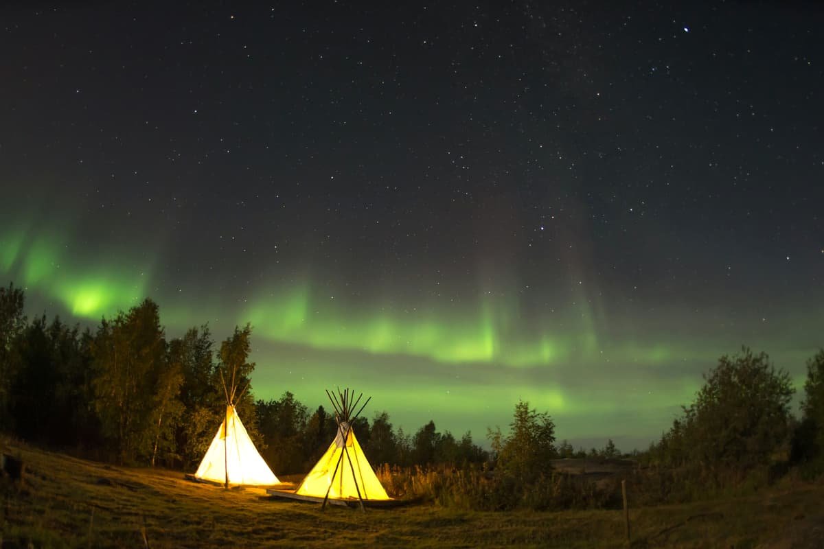 Camping tent in forest during midnight in Great Slave Lake shoreline at Hay River, Northwest Territories