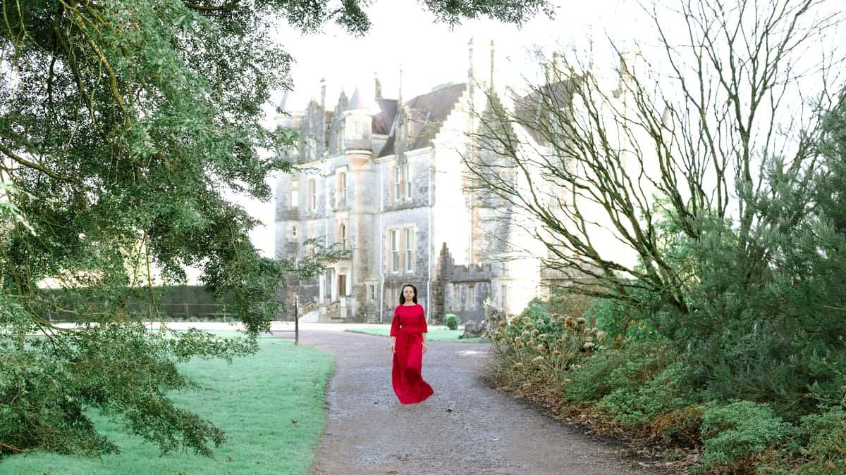 Woman in red dress walking on pathway, date night in Nova Scotia