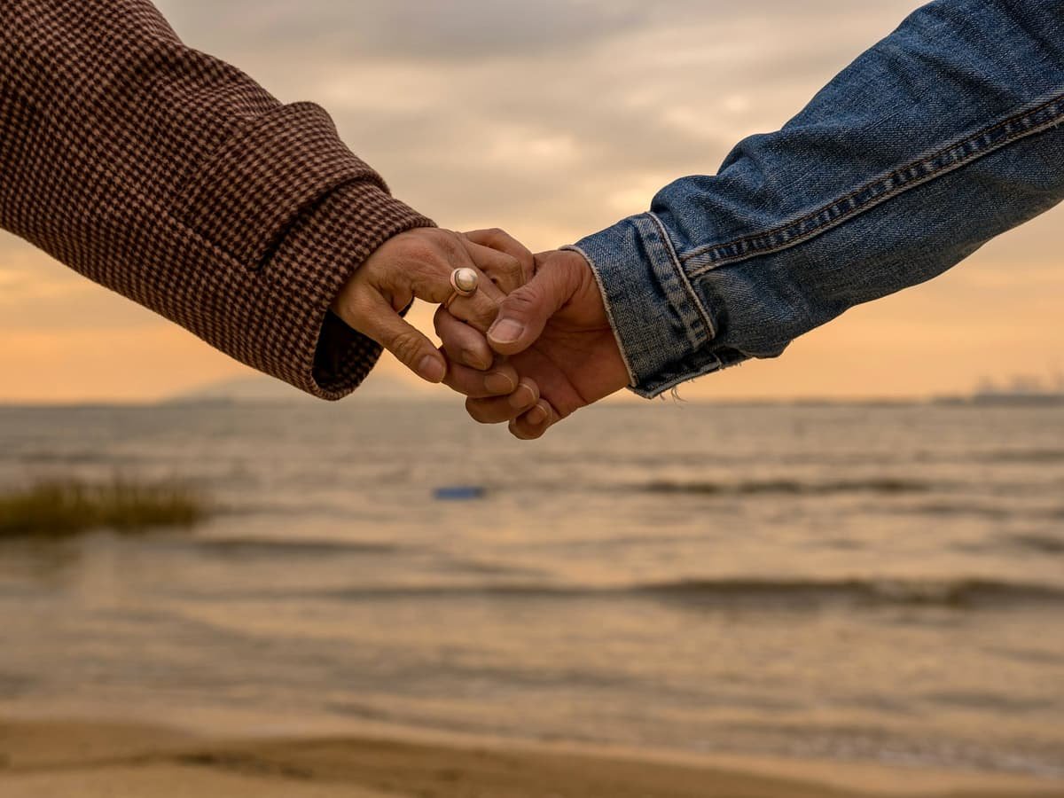 Person in blue denim jeans and brown and white checked shirt holding hands with woman: date idea in Nunavut
