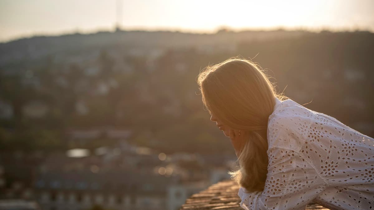 Woman looking out over city at sunset, date night in Ontario