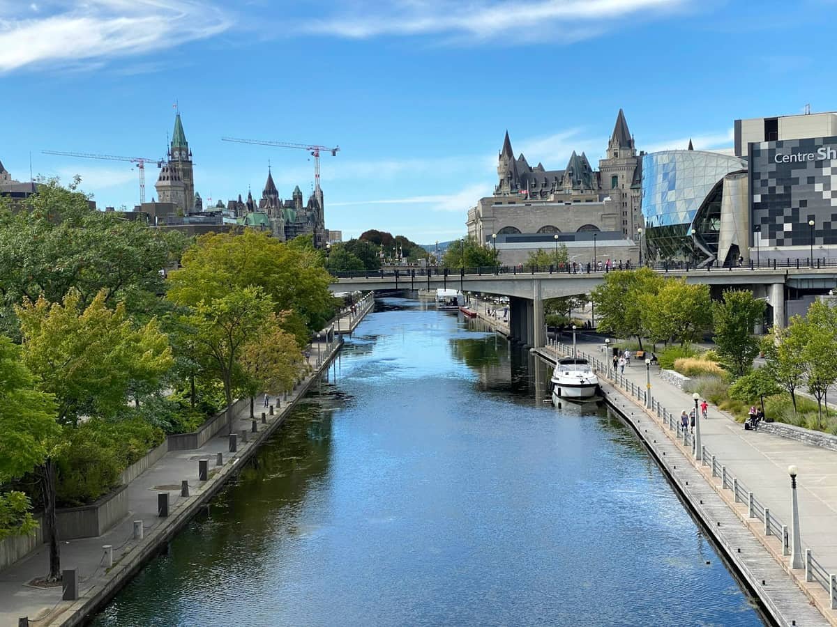 A river running through a city next to tall buildings: date idea in Ontario