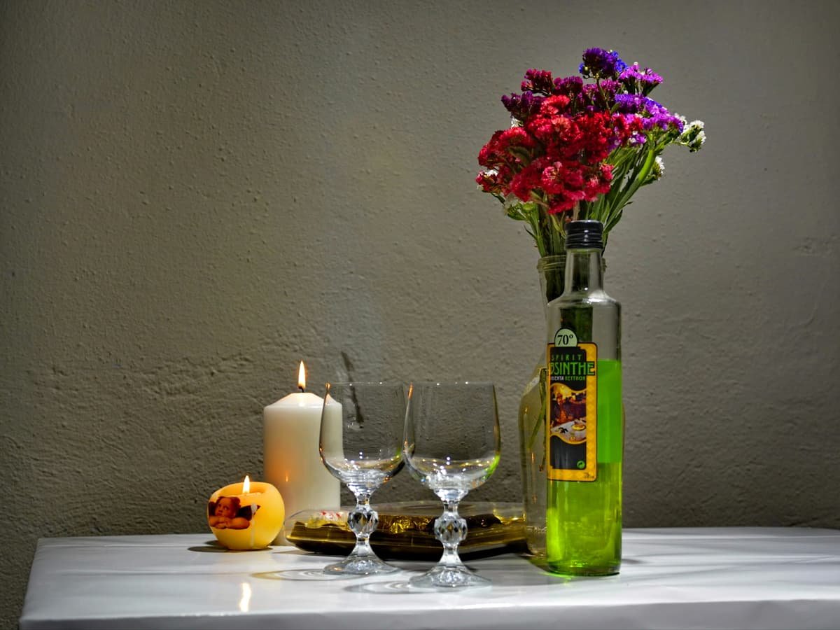 Red roses in green glass vase: date idea on Prince Edward Island