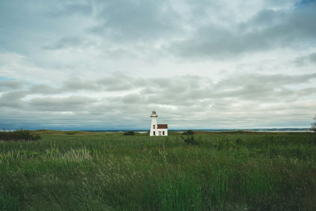 White lighthouse surrounded by grass field in Summerside, Prince Edward Island