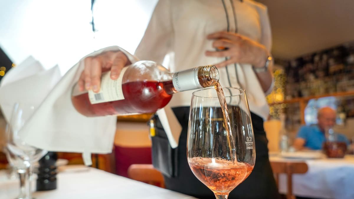 A person sitting at a table with wine glasses, date night in Quebec