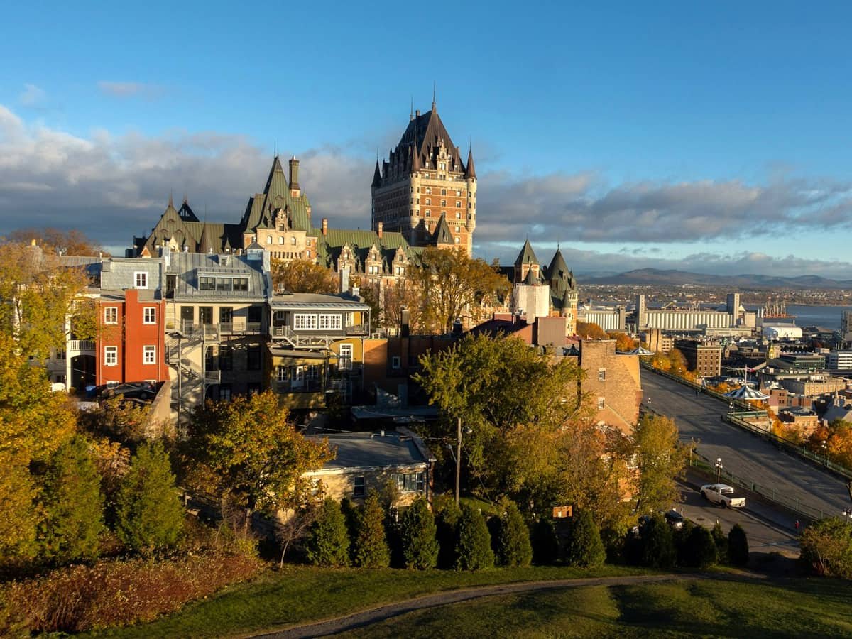 Few cars on road near concrete buildings viewing sea: date idea in Quebec