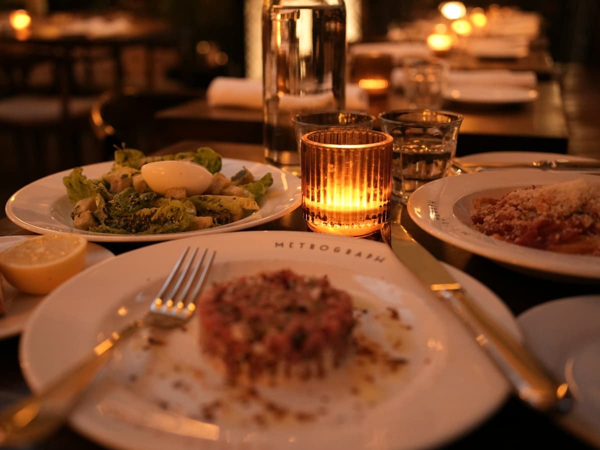 A romantic dinner setting with food and candles: date idea in Quebec