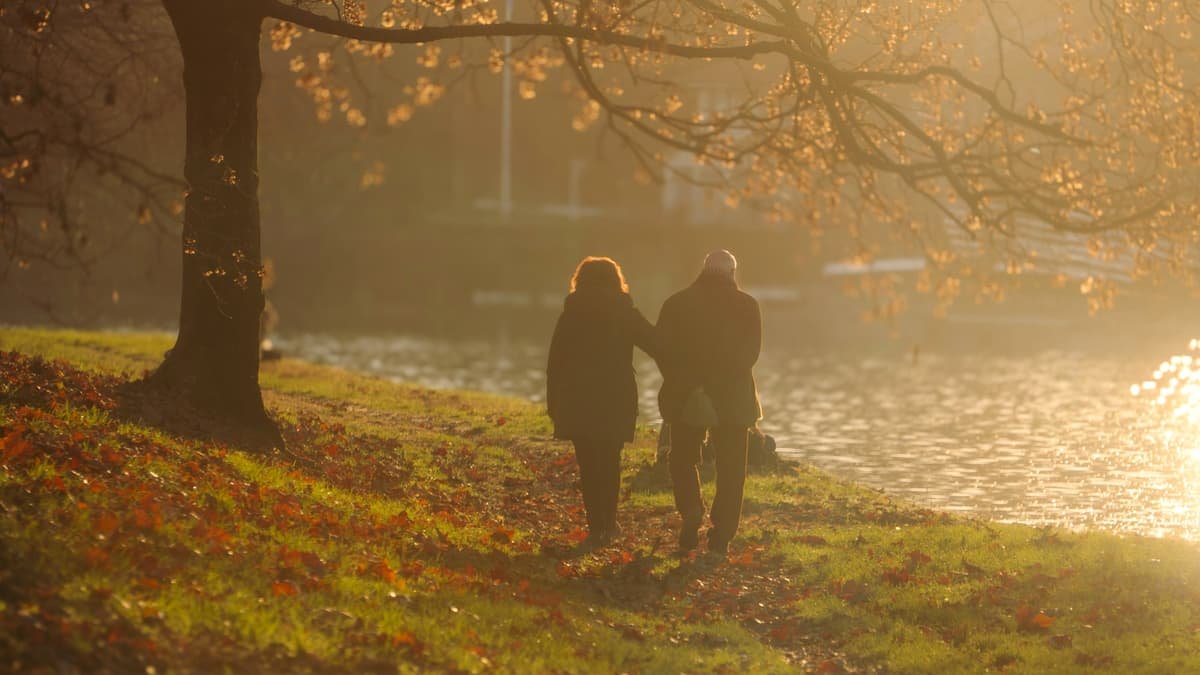 Couple walking by a river at sunset, date night in Saskatchewan