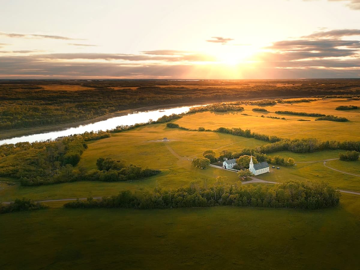 Rural landscape with a river and a building at sunset: date idea in Saskatchewan