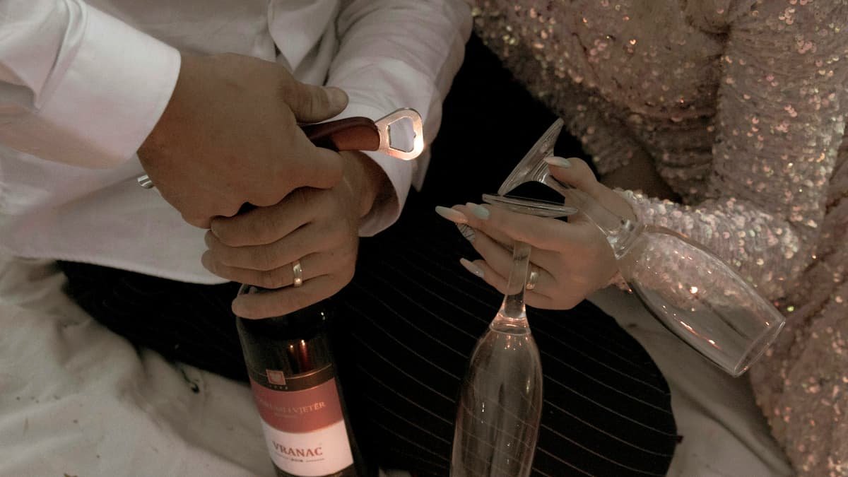 Person holding clear glass bottle, date night in Yukon