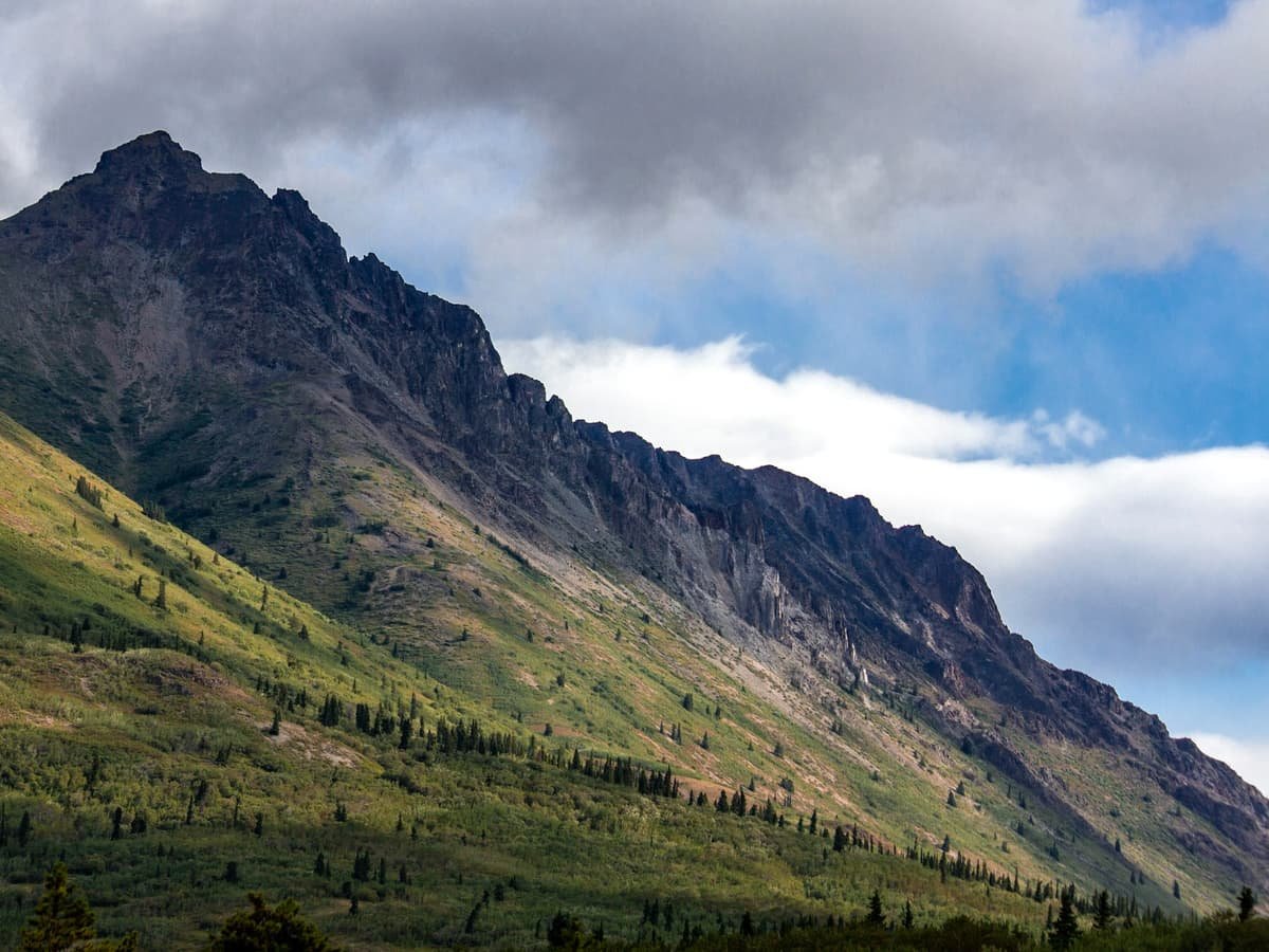 A large mountain with a forest below it: date idea in Yukon