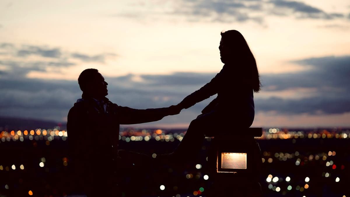 A couple of people sitting on top of a bench, date night in Yukon