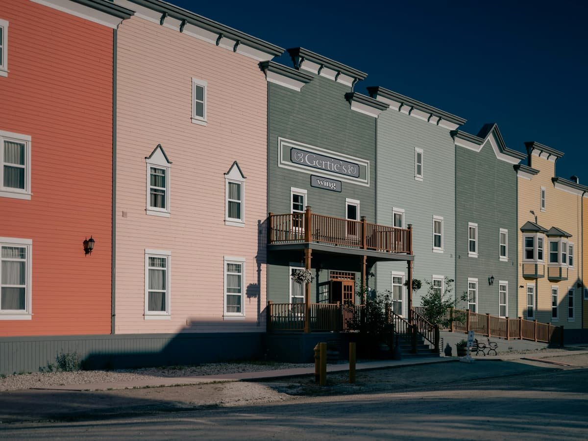 Colorful buildings line a quiet street in the sun: date idea in Yukon