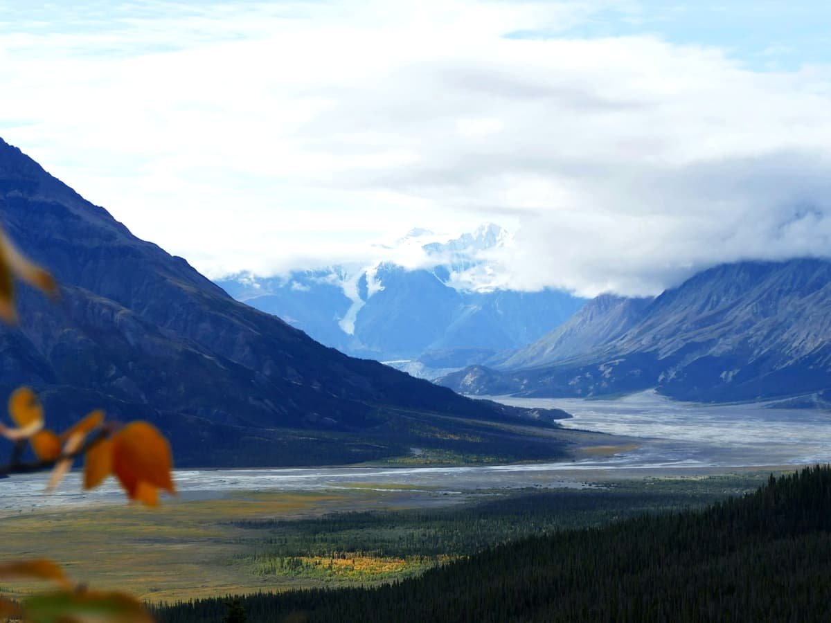 A view of a valley with mountains in the background: date idea in Yukon